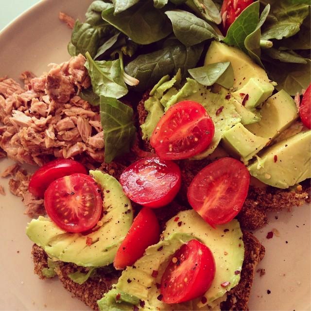 Avocado on Two Slices of Brown Bread Topped with Tomatoes, Spinach and a Side Portion of Tuna.