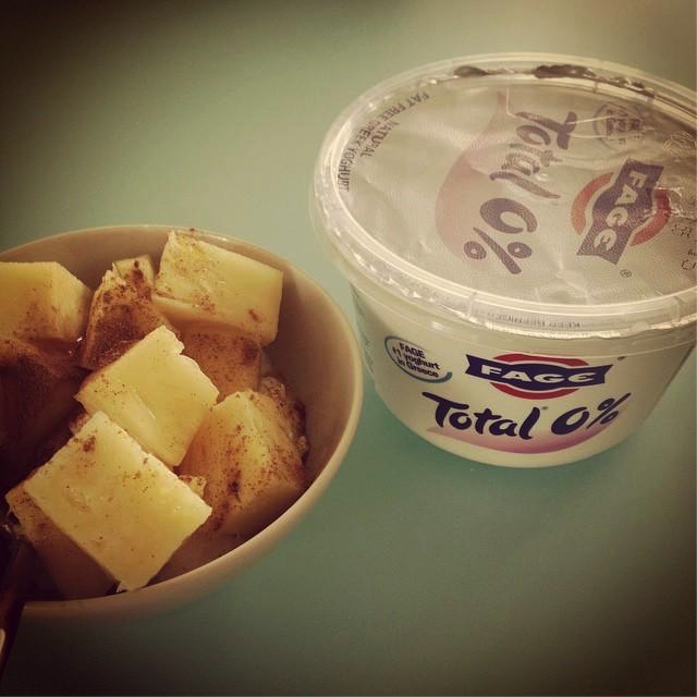 Bowl of Pineapple with Cinnamon topping alongside Fage Yogurt